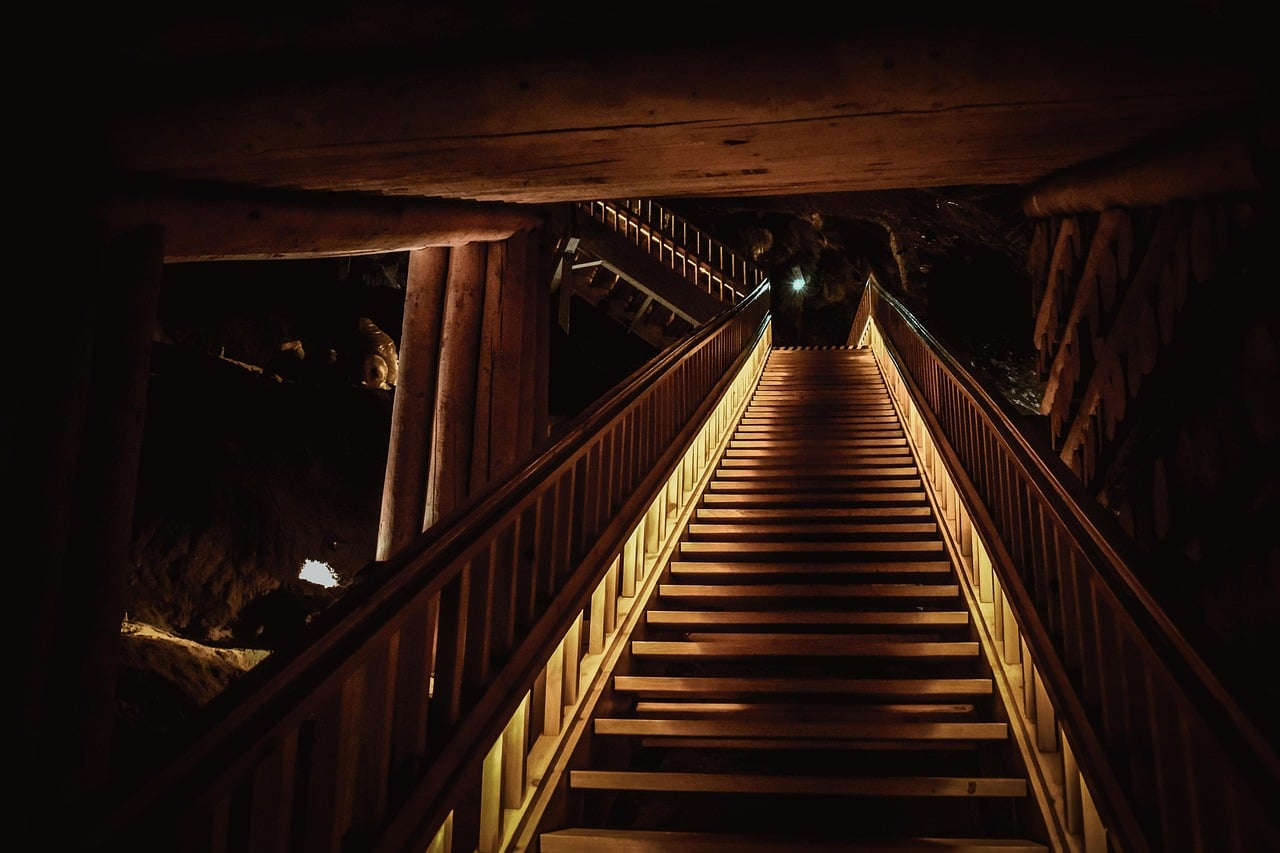 Wooden staircase descending into the underground tourist route at Wieliczka Salt Mine