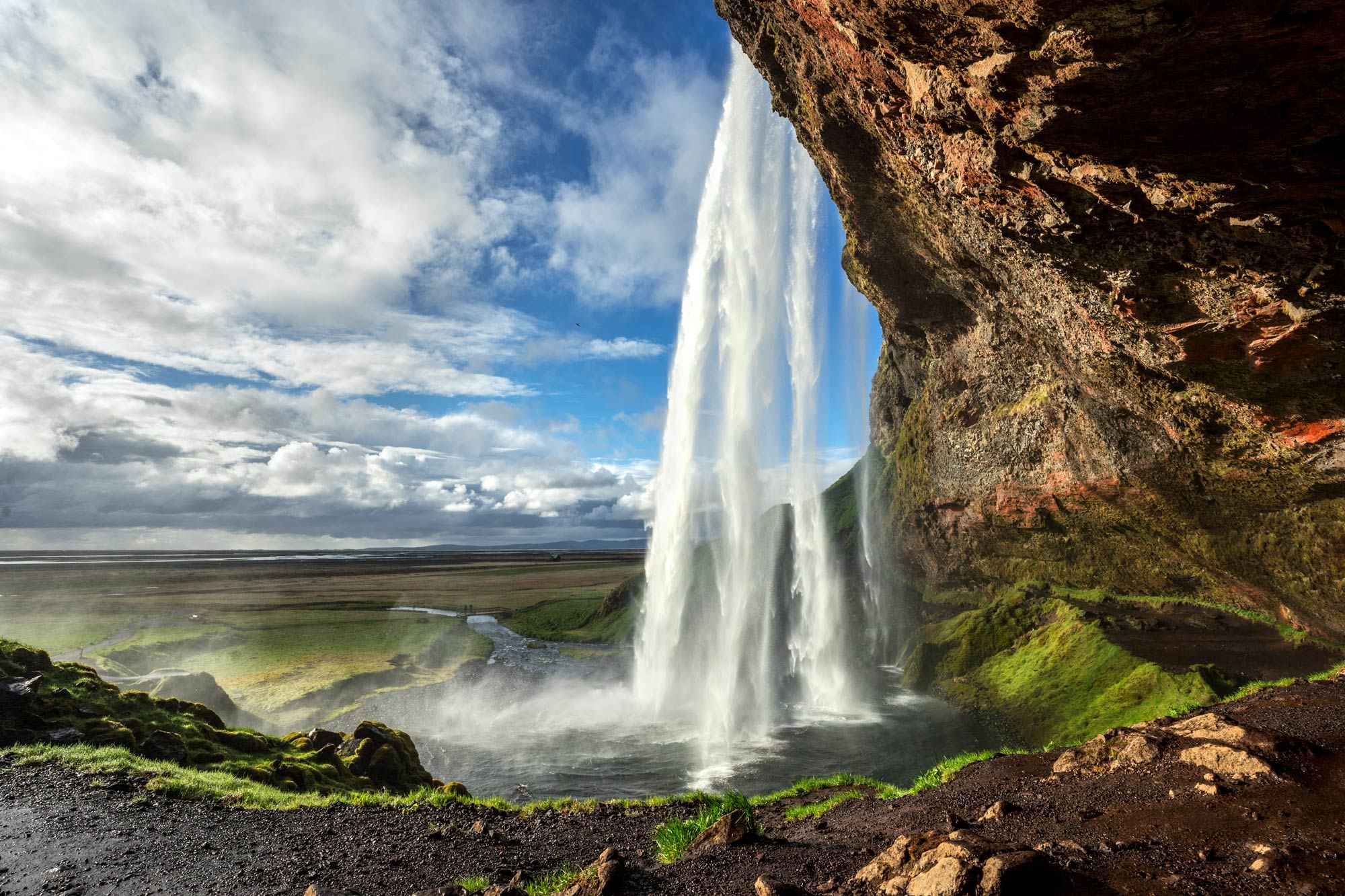 A waterfall plunges from cliffs
