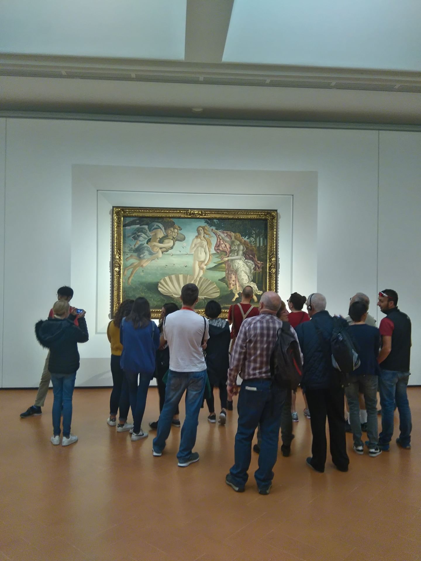 Group of visitors admiring the painting of the Birth Of Venus By Alessandro Botticelli in the Uffizi Gallery in Florence