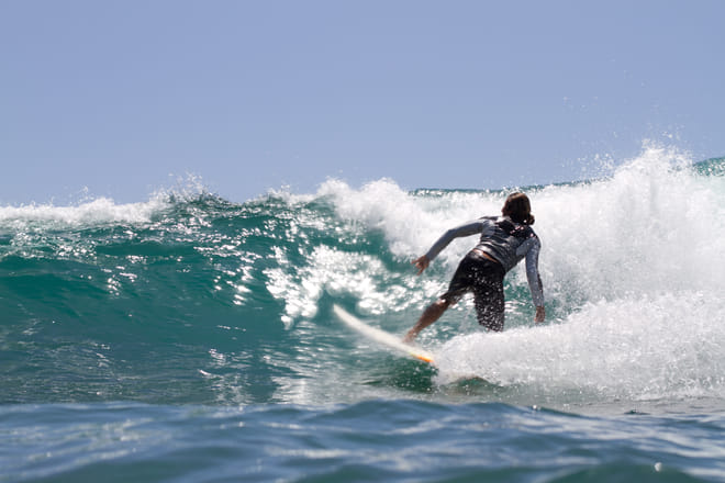 Surfer riding a breaking wave at Costa Azul in Los Cabos during a surf session