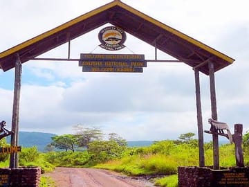 Entrance gate welcoming visitors to Arusha National Park for a day safari adventure.