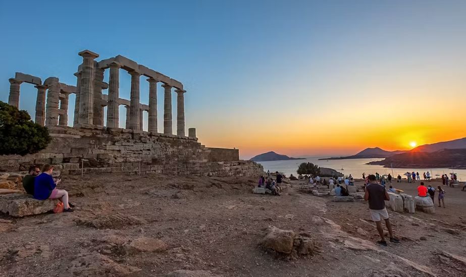 Sunset over the Temple of Poseidon, highlighting its iconic Doric columns.