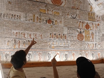 Expert guide explaining the the colorful ancient hieroglyphs inside the tomb of Rameses II i the valley of kings Luxor