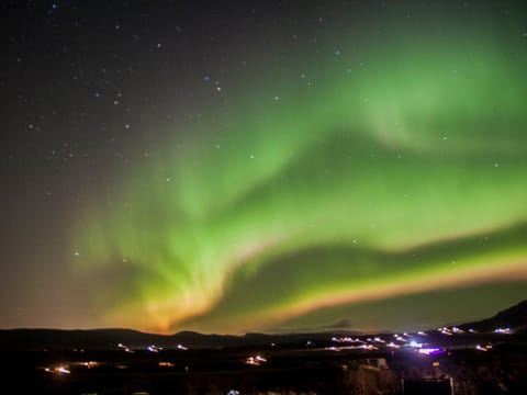 Colorful aurora with shades of red and orange seen from Kerið crater