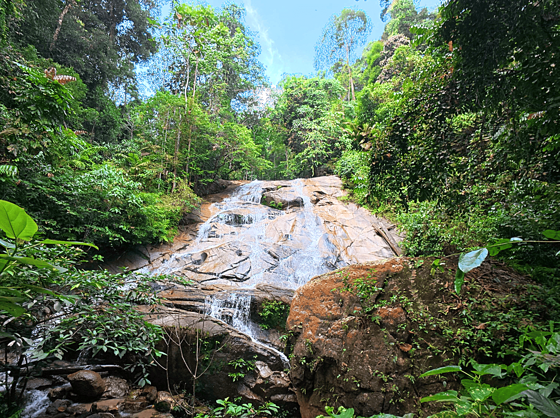 Lush green rainforest and cascading waterfall at Jeram Kubang Gajah (Sofea Jane waterfall) in Kemensah, Selangor.