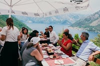 Traditional Montenegrin lunch stop with local specialties and panoramic views over the Bay of Kotor during the Jeep tour.
