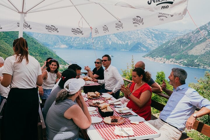 Traditional Montenegrin lunch stop with local specialties and panoramic views over the Bay of Kotor during the Jeep tour.