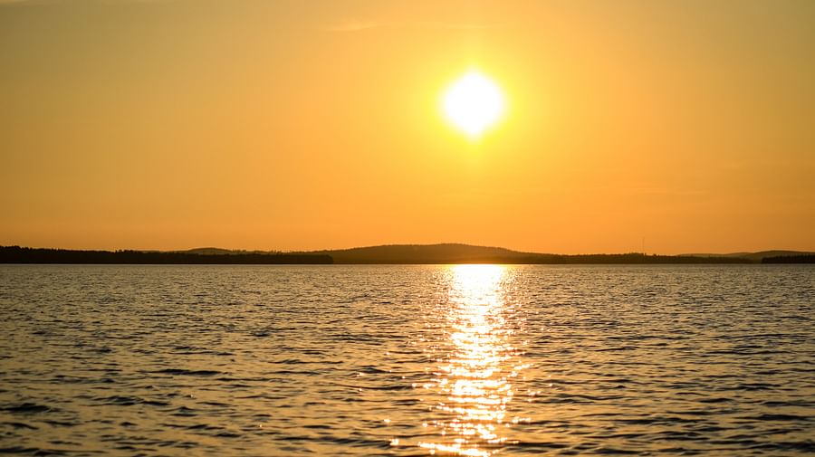 Canoeing under the Midnight Sun on a peaceful lake in Finnish Lapland