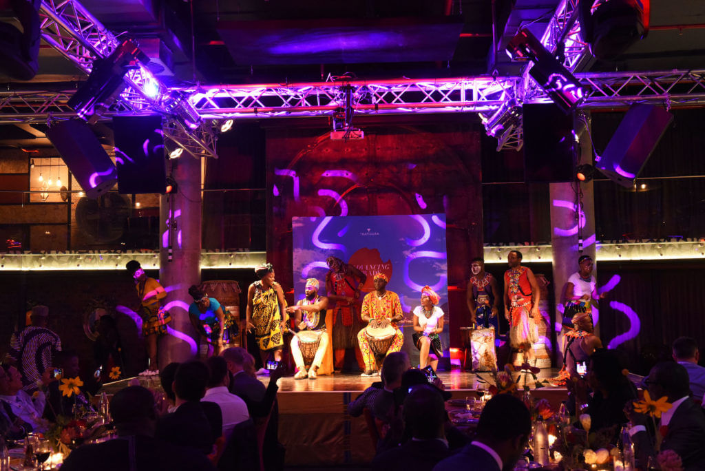 Guests playing djembe drums together during the Spice Experience at Gold Restaurant Cape Town.