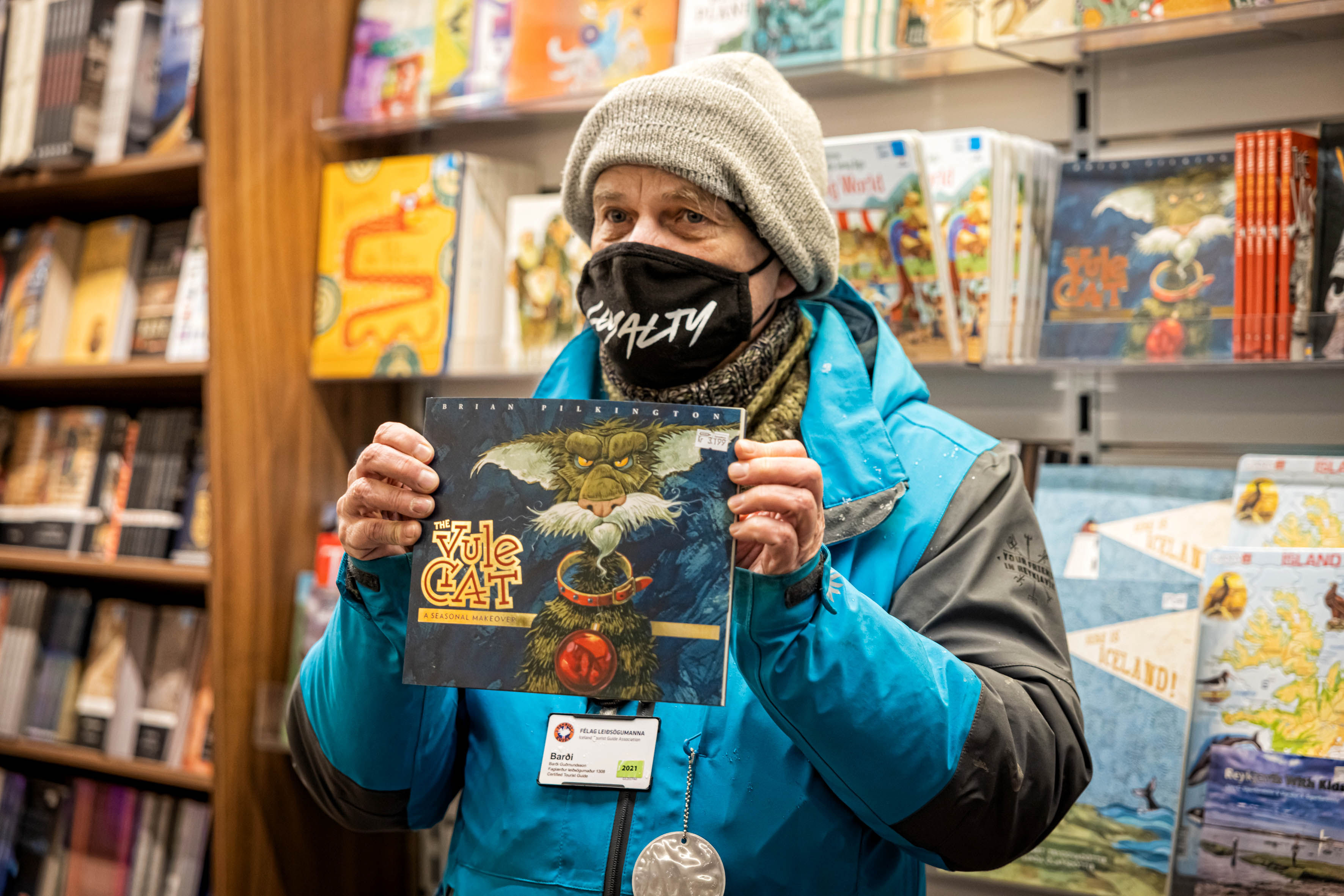 A guide from Your Friend in Reykjavik holding a book up to show to others