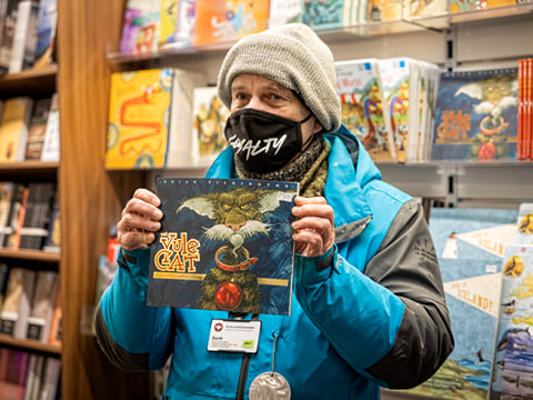 A guide from Your Friend in Reykjavik holding a book up to show to others