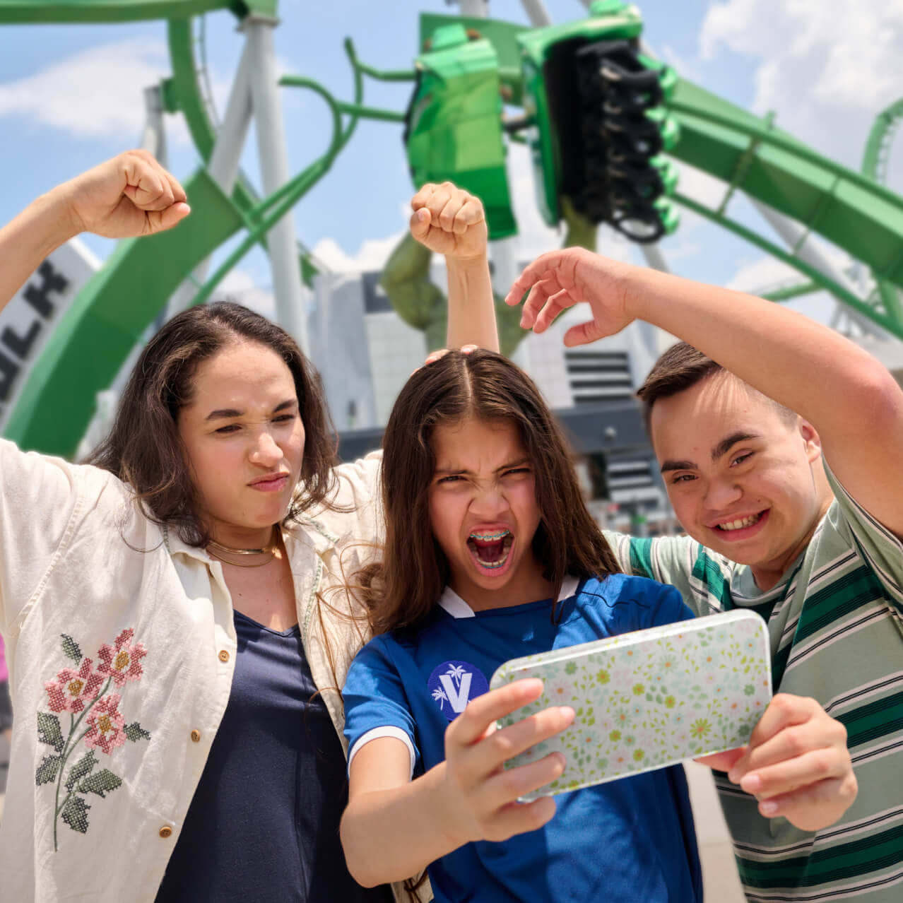 Family posing near The Incredible Hulk Coaster at Universal Islands of Adventure