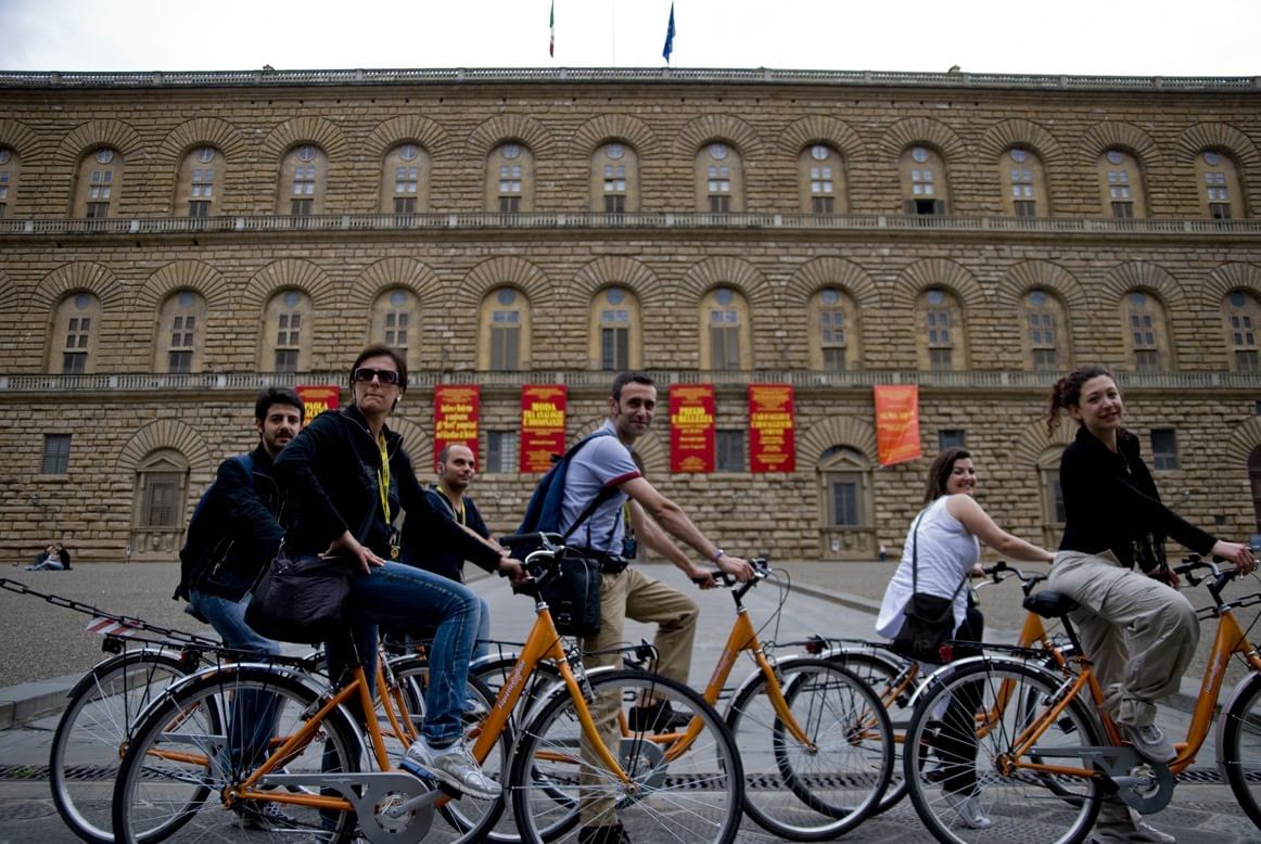 Customers on their bikes stopping in front of Pitti Palace 