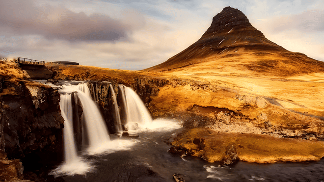A beautiful mountain with a quaint waterfall in the foreground