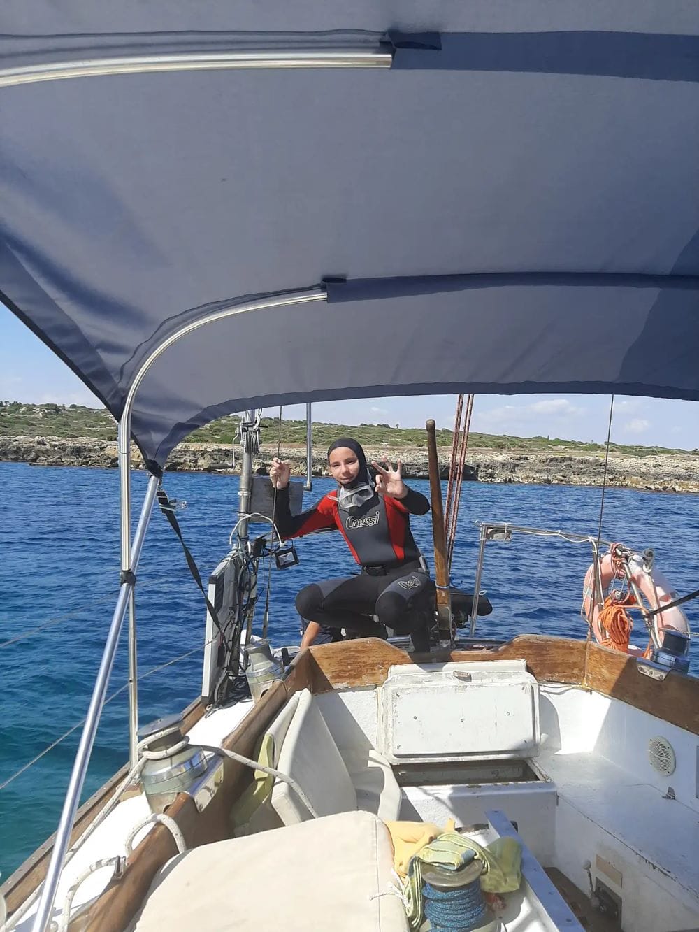 Tour participant on boat ready for scuba in Siracusa