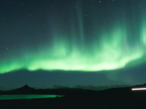 Northern Lights in the night's sky over some mountains