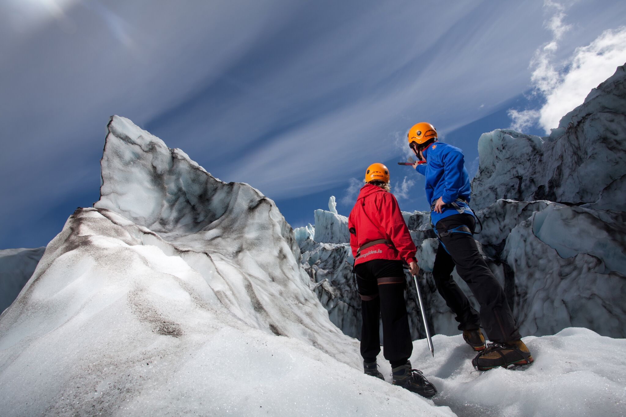 Couple of hiker looking up at glacier during Skaftafell glacier tour