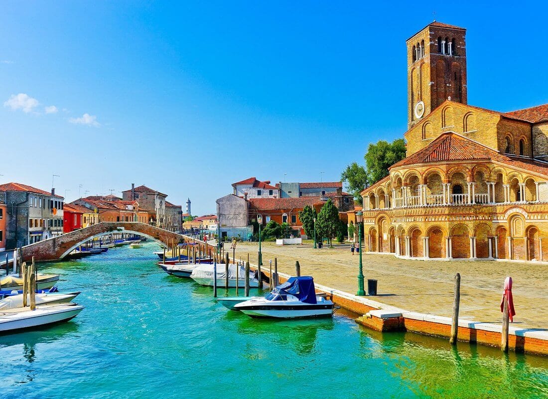 Murano bridge and church along canal, Venice Italy
