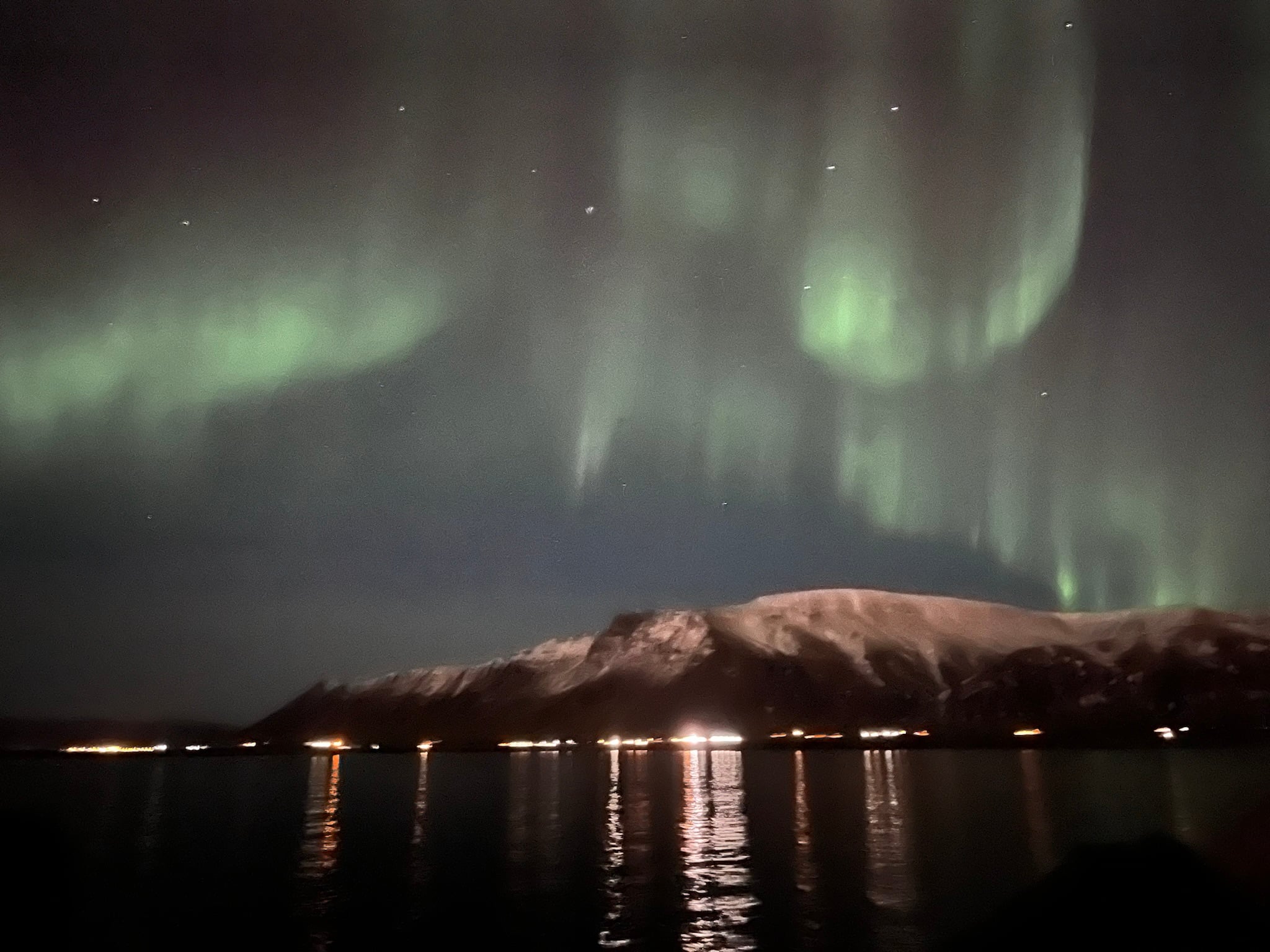 Bright green Aurora Borealis stretching across the dark Icelandic sky