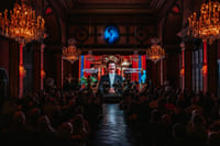 Performer on stage during live classical concert Vienna with orchestra and multimedia show