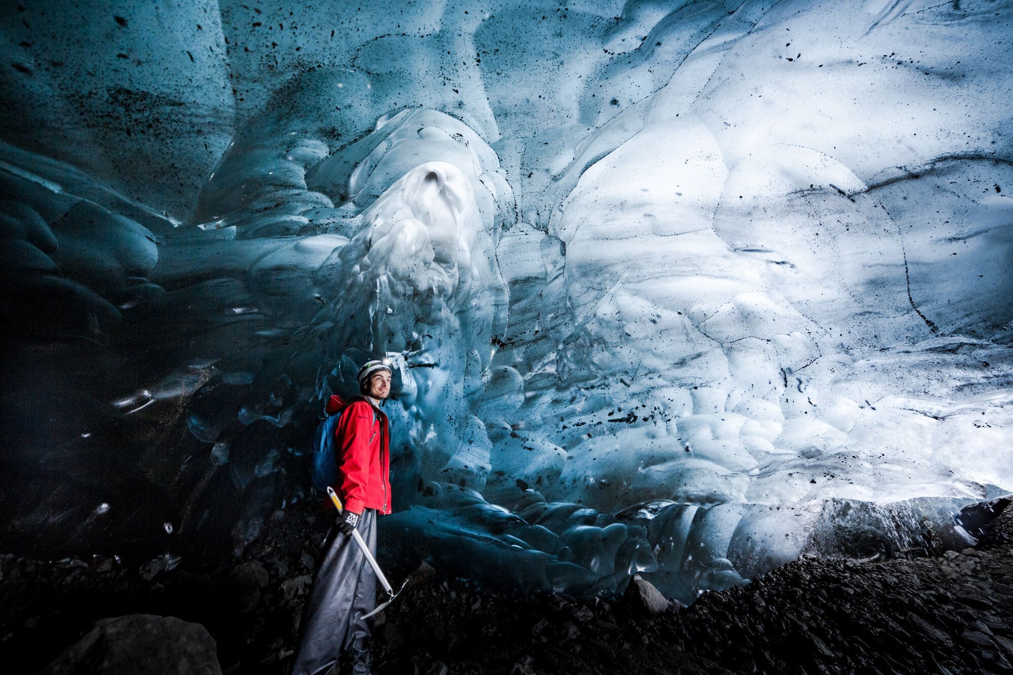 People exploring ice cave during glacier hike and ice cave tour Iceland