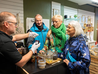 Travellers inside a store talking to the employee