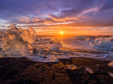During sunset Jokulsarlon transforms into a mesmerising show of the sun reflecting on the ice