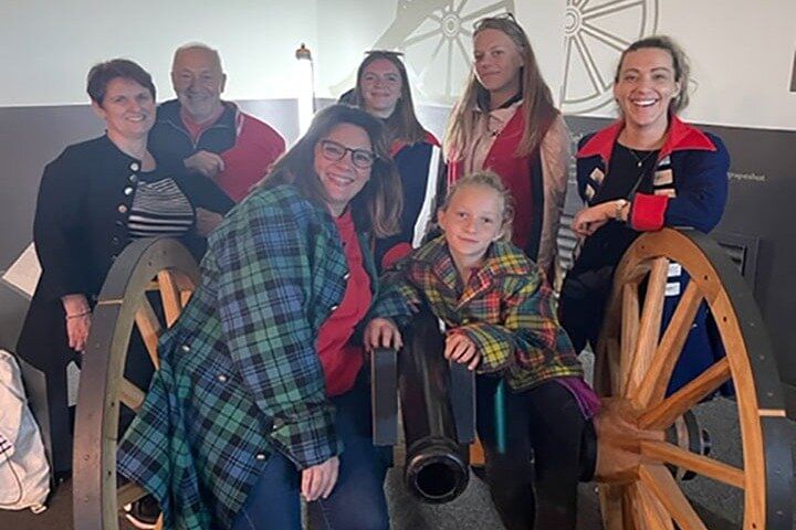 Family of Go Highlands Guests at Culloden Exhibition Centre sitting round a Canon