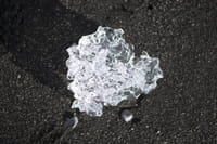 Shining ice diamond on black sand at Diamond beach