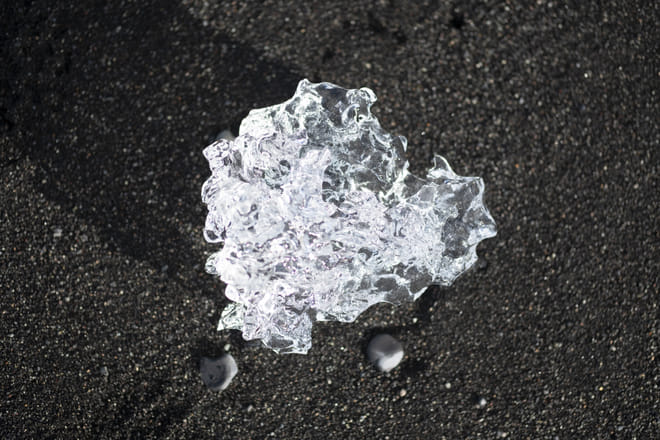 Shining ice diamond on black sand at Diamond beach