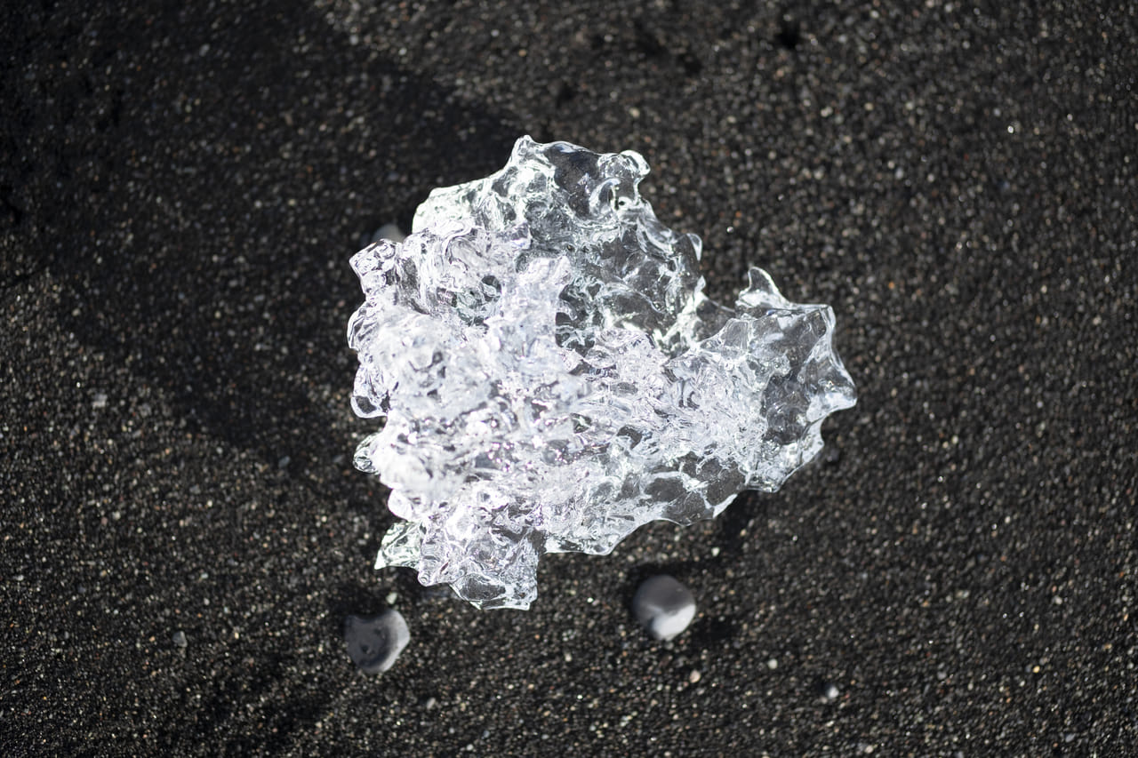 Shining ice diamond on black sand at Diamond beach