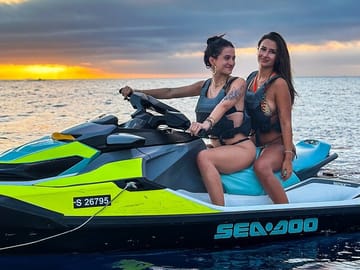 Two ladies enjoying a thrilling Seadoo jet ski ride at sunset during the 45-minute Jet Ski Safari to Malta’s Blue Lagoon.