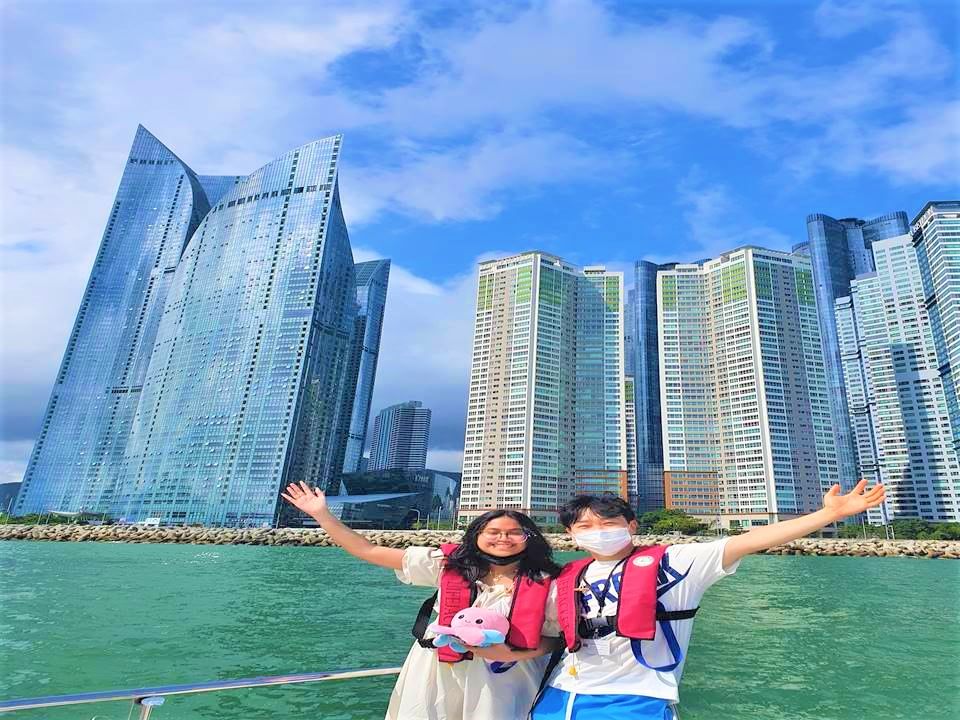 The Haeundae skyscrapers and coastline seen from the ocean during a yacht ride.