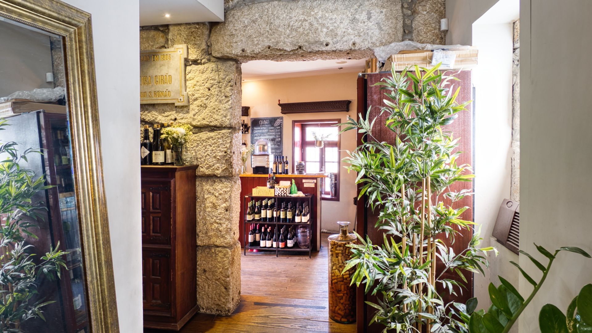 Interior of a hidden Porto wine bar with shelves of Portuguese wines and rustic decor