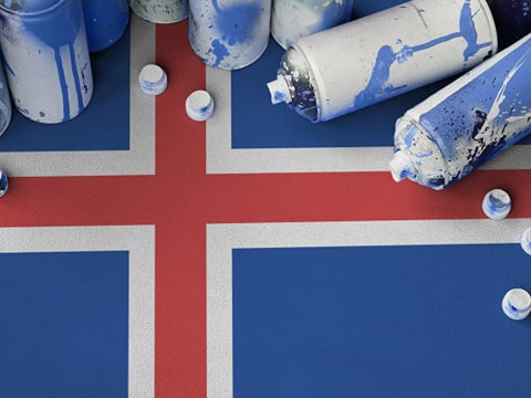 A flag of Iceland with spray cans on top of it