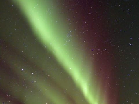 Several stripes of aurora with purple shades seen from Snæfellsnes peninsula