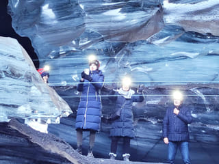 People deep inside a glacier.