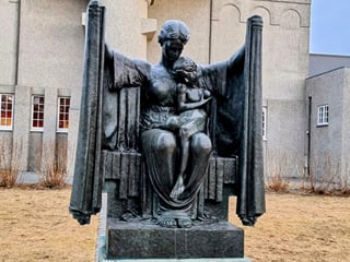 A statue depicting a mother protecting her child