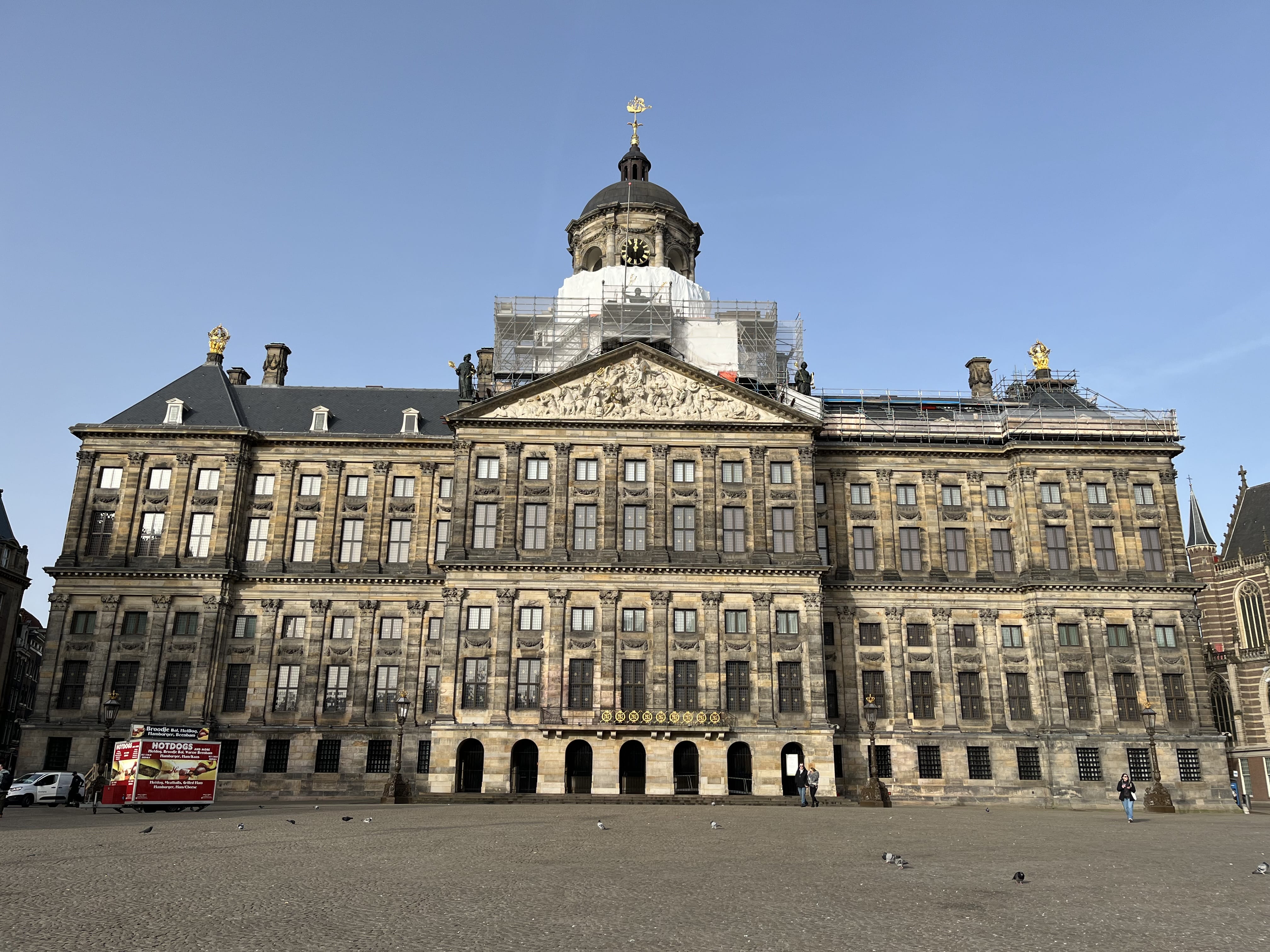 Royal Palace on Dam Square in Amsterdam with visitors during a guided walking tour shore excursion