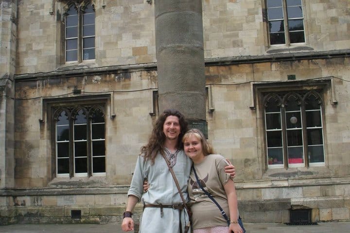 A Viking guide stood with a young lady in front of York's Roman Column after a tour.