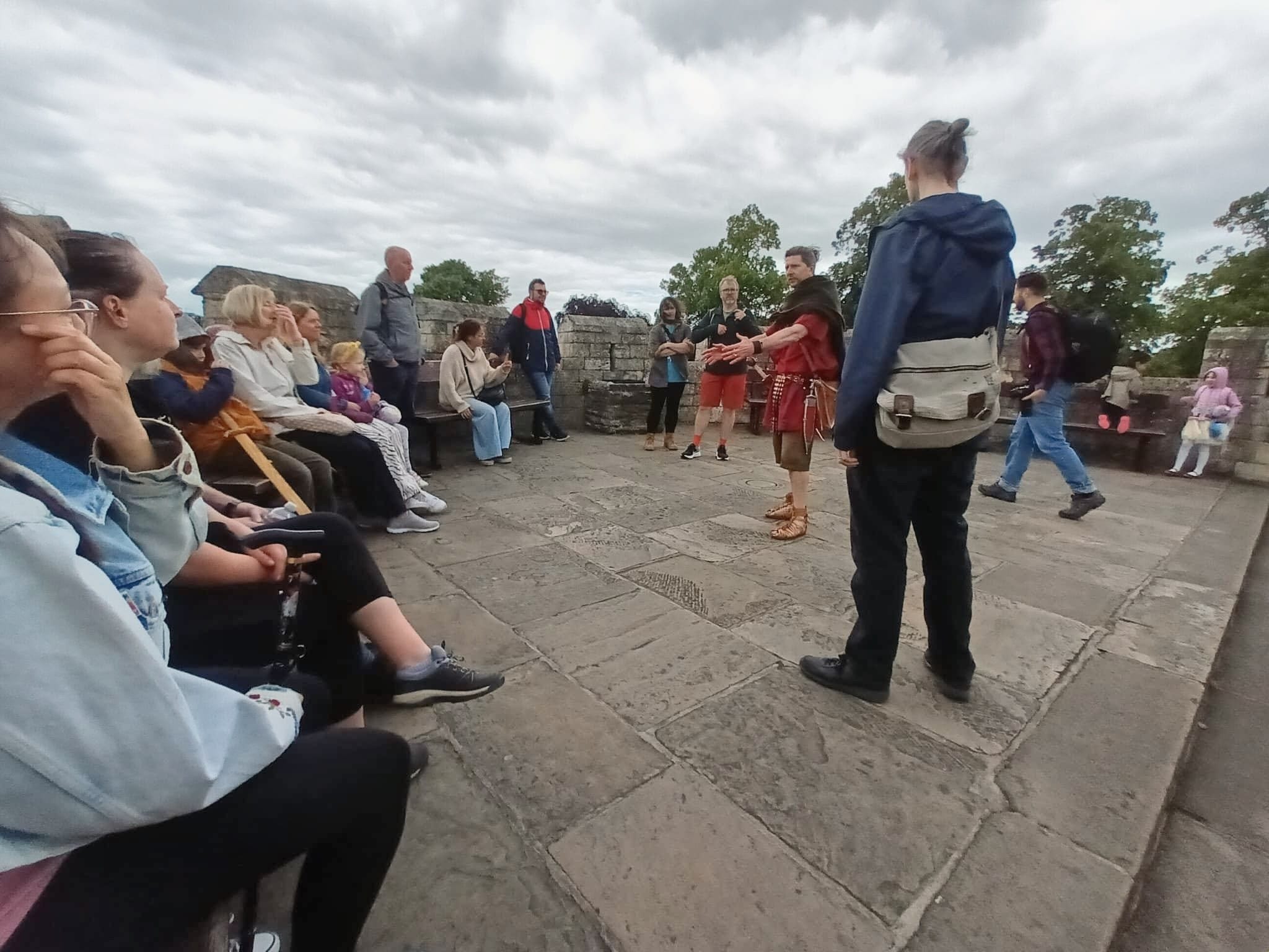 A costumed Roman guide with guests at the Robin Hood Tower, York.