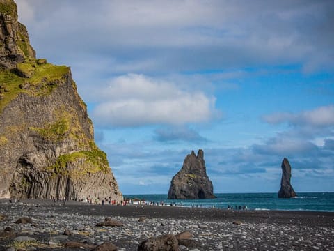 Black beach of Reynisfjara with basalt columns and rock formations