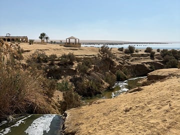Scenic view of the natural water springs and desert landscape in Al Fayoum Oasis, Egypt.