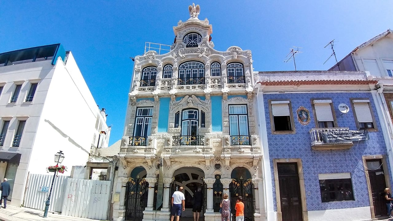 Art Nouveau Museum facade in Aveiro with ornate windows, tiles, and pedestrians