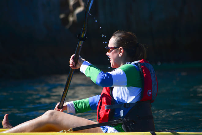 Woman kayaking los cabos sea of cortez near cliffs paddling yellow kayak cabo san lucas ocean adventure coastal rock formations mexico