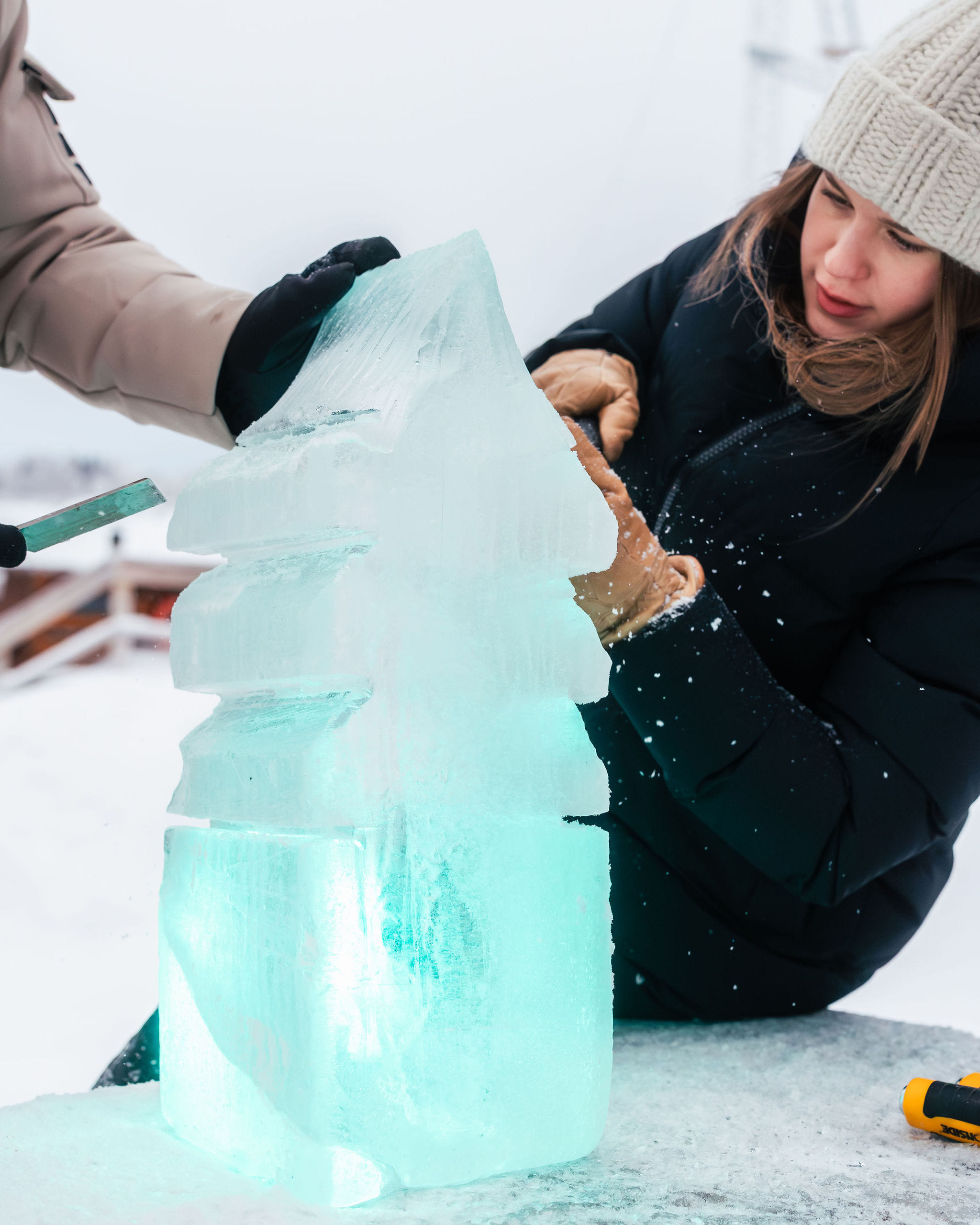 Close up from a couple sculpting an ice block