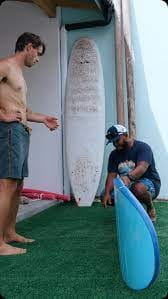 Surfboards lined up on the beach at Arifiyaalho Surf School in Fuvahmulah.