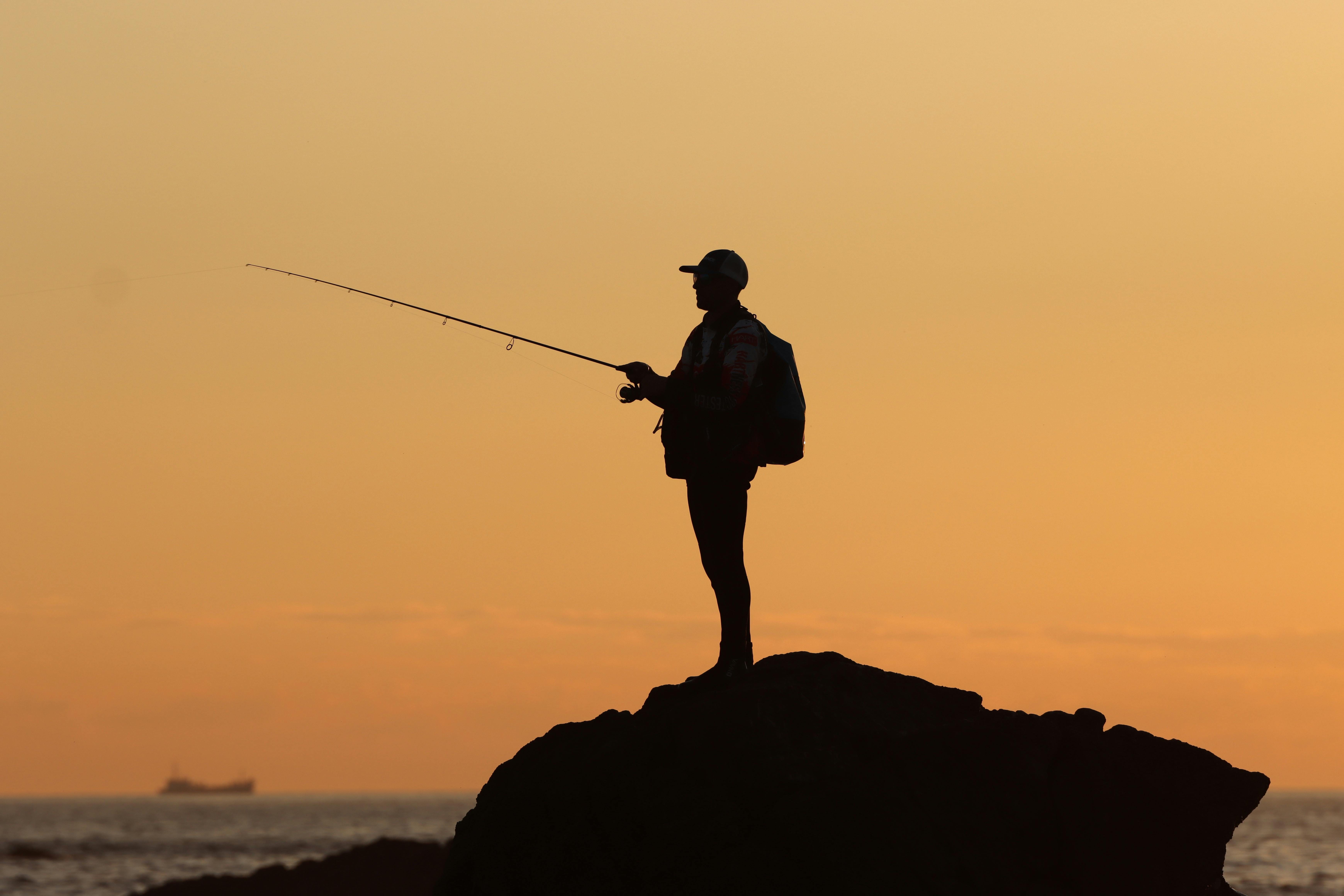 Fisherman casting line on a Foz beach.