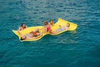Relax and soak up the sun on a floating mat in the crystal-clear waters of Los Cabos. Perfect for fun, sun, and refreshing drinks with friends!