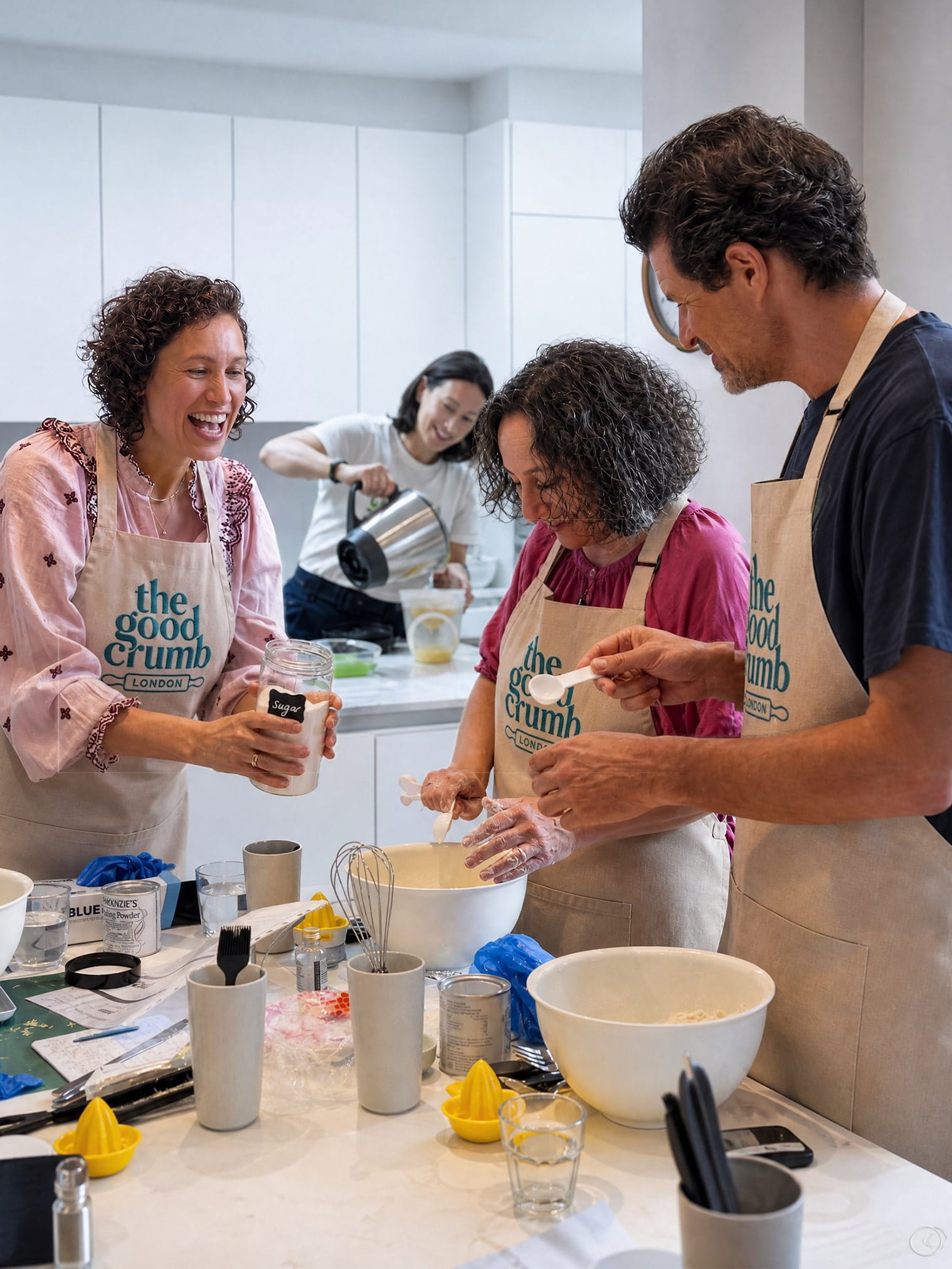 Two guests being given flour to add to their scone mixture